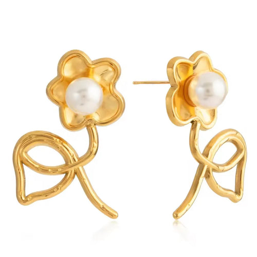 A pair of gold flower stud earrings with white pearl centers, displayed on a clean white background.