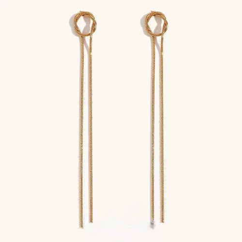 A pair of gold-toned long drop earrings with circular top hoops and thin chain-like drops, shown on a plain light background.