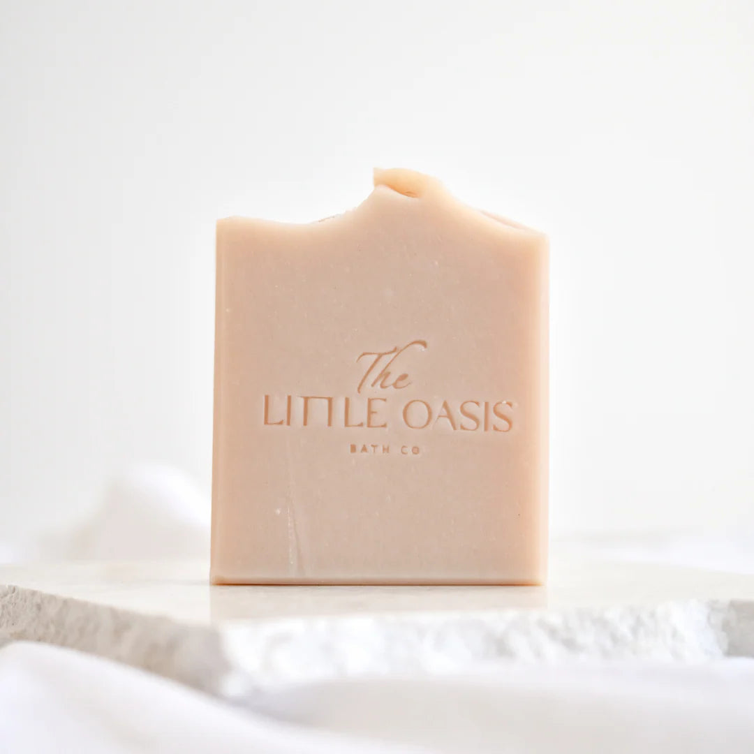 Bar of soap with 'The Little Oasis Bath Co' branding on a white background